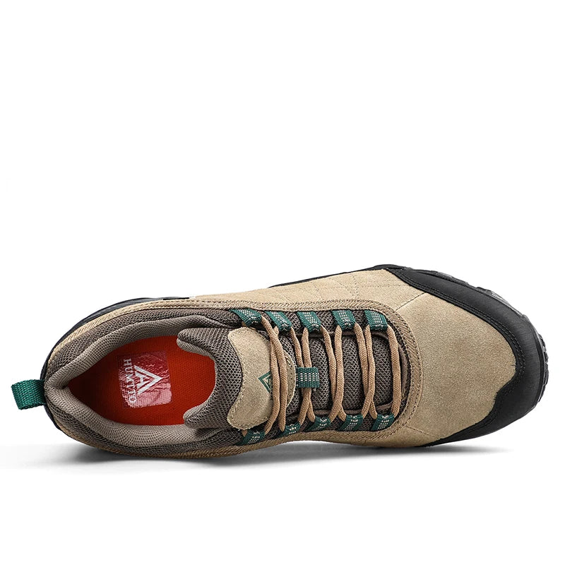Beige hiking shoe with green laces on a white background