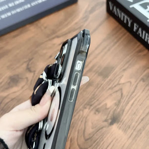 Person holding a iphone case with multiple compartments on a wooden surface