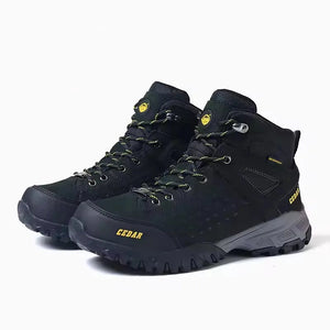 Black hiking boots with yellow accents on a white background