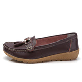 Women's leather loafers with metal tassel detail, round toe, and rubber sole