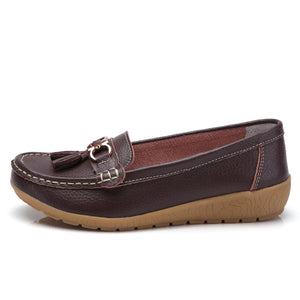 Women's leather loafers with metal tassel detail, round toe, and rubber sole