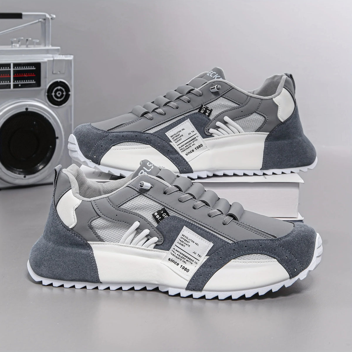 Gray and white sneakers with a vintage radio in the background