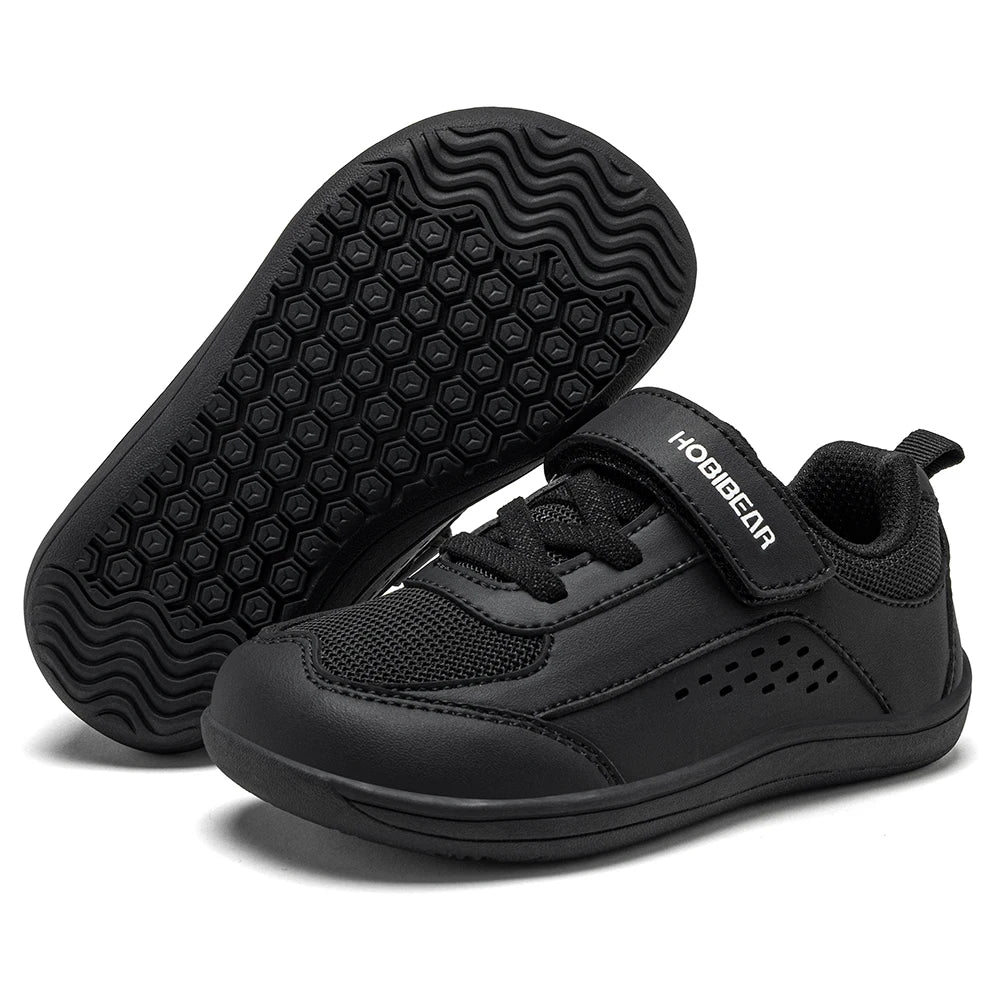A pair of black toddler sneakers, with one shoe showing the textured sole and the other showing the side profile with a hook-and-loop strap featuring the brand name HOBIEAR.
