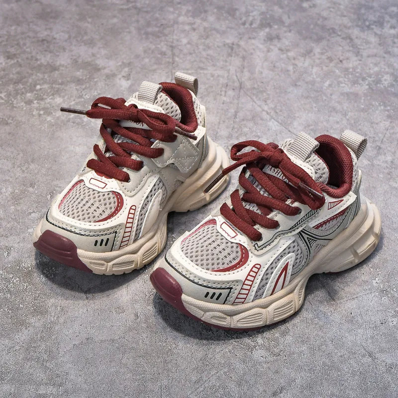 Pair of white and red sneakers on a gray concrete surface