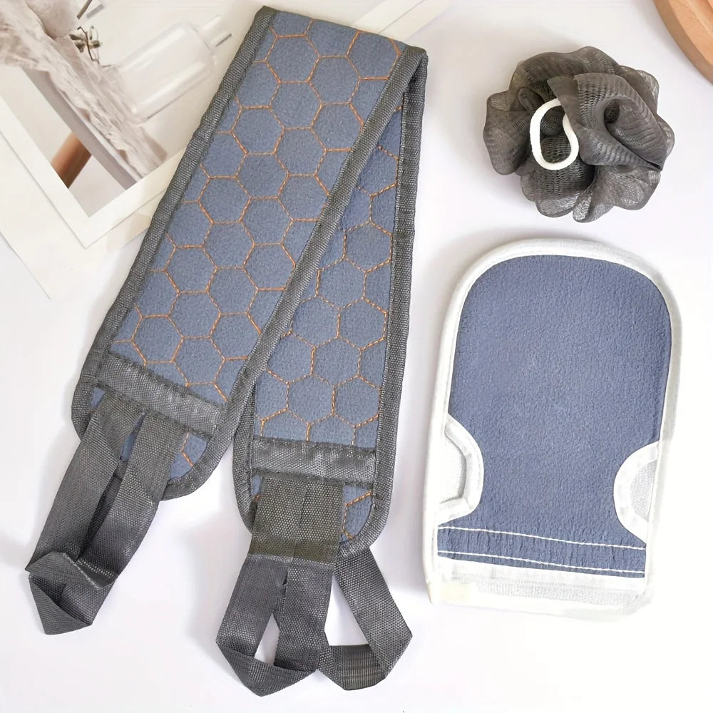 Gray and blue bath mitt, scrubber, and body brush on a white surface