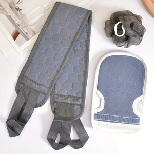 Gray and blue bath mitt, scrubber, and body brush on a white surface