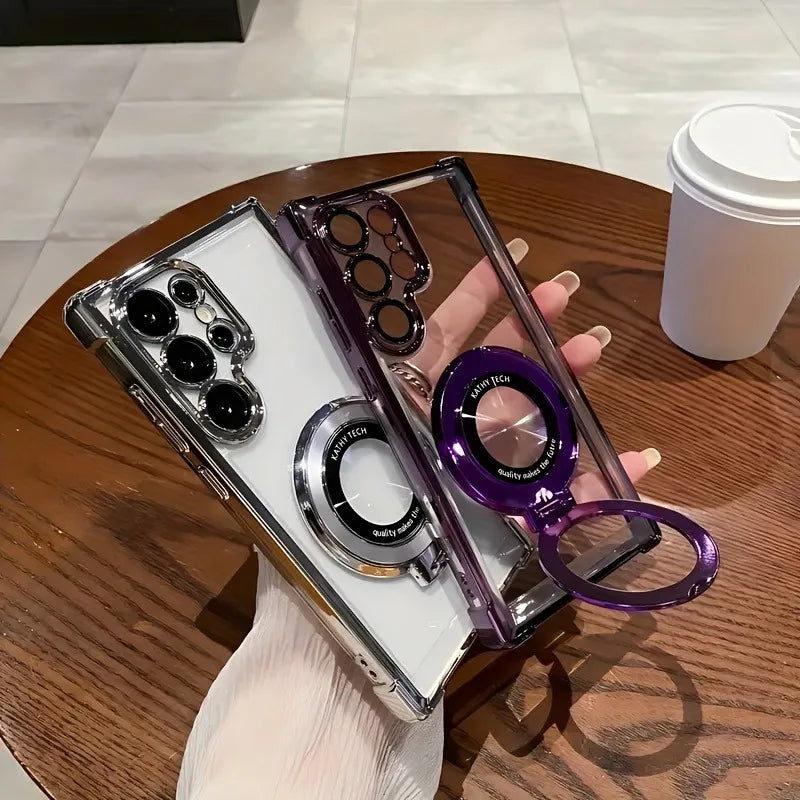 Phone case with camera lens protector held by a hand on a wooden table with a coffee cup in the background.
