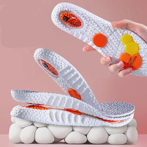 White sports shoes with orange and yellow accents on a pink background, featuring the brand 'Boost Sports'.