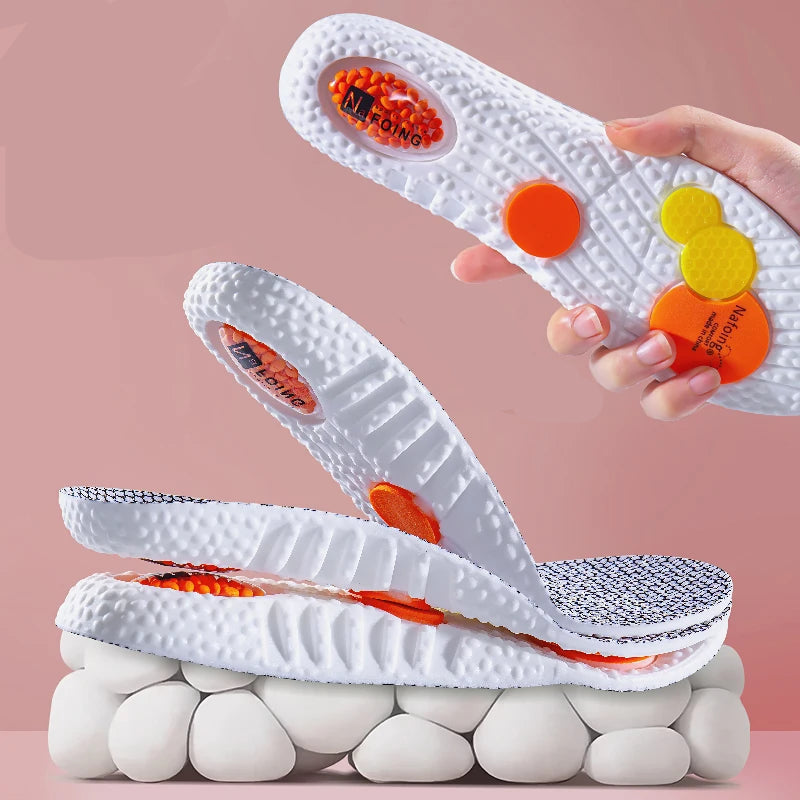 White sports shoes with orange and yellow accents on a pink background, featuring the brand 'Boost Sports'.