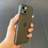 Hand holding a Ultra thin matte translucent TPU iPhone case with a clear background