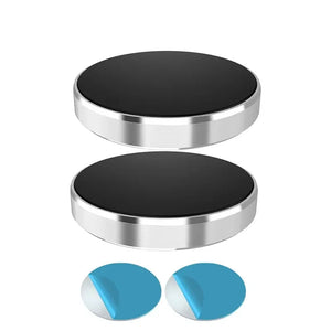 Two metallic circular holders with black centers on a white background, accompanied by two blue circular objects.