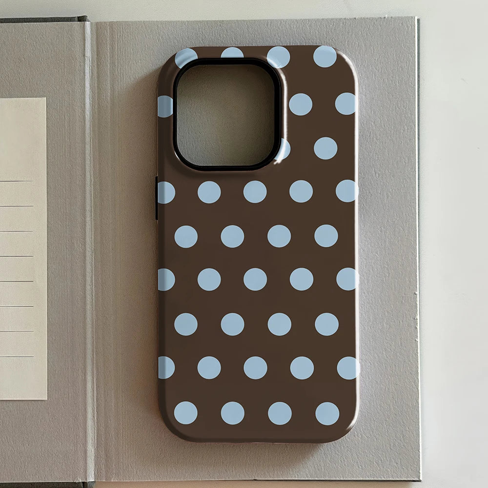 iPhone case with blue polka dots on a brown background