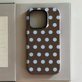 iPhone case with blue polka dots on a brown background