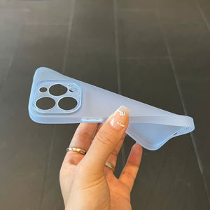 Hand holding a clear phone case with a dark background