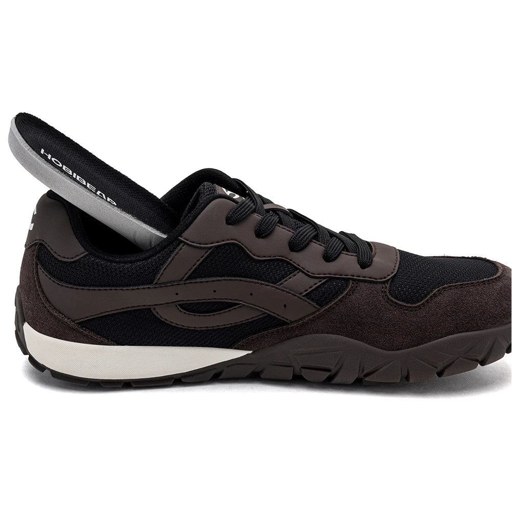 A dark brown and black athletic shoe with a white midsole, shown in a side profile with the heel pulled back to reveal the inner lining. The brand 'HossGear' is visible on the lining.