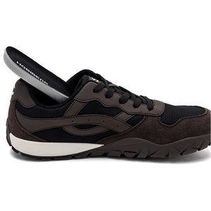 A dark brown and black athletic shoe with a white midsole, shown in a side profile with the heel pulled back to reveal the inner lining. The brand 'HossGear' is visible on the lining.