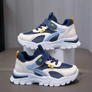 Pair of blue and white children's sneakers on a gray background