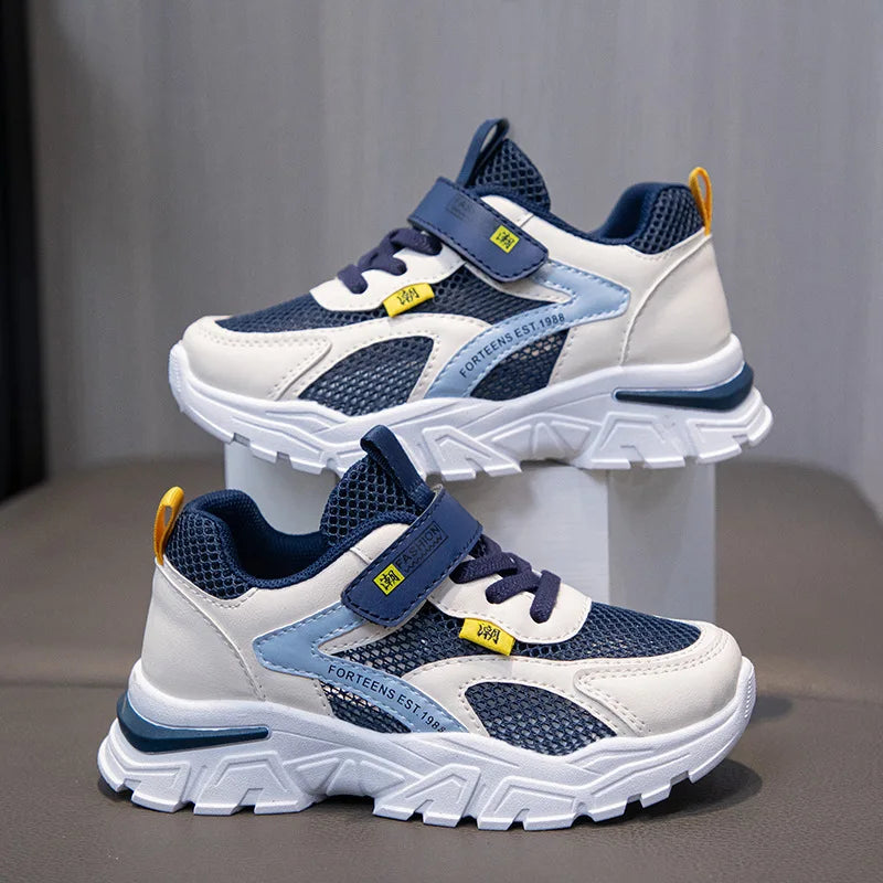 Pair of blue and white children's sneakers on a gray background