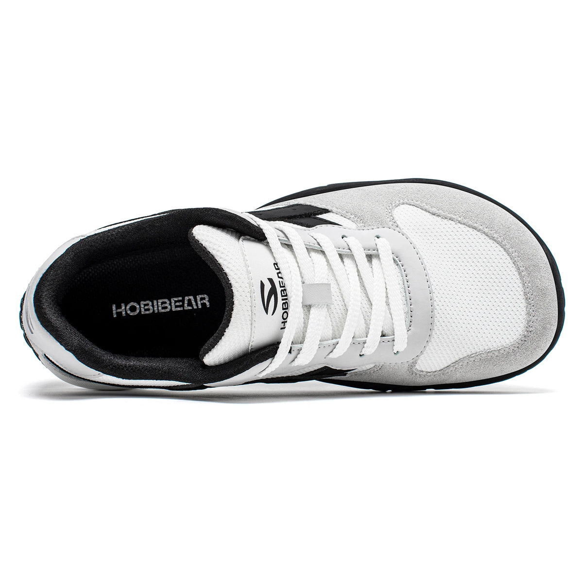 White athletic shoe with black sole on a white background