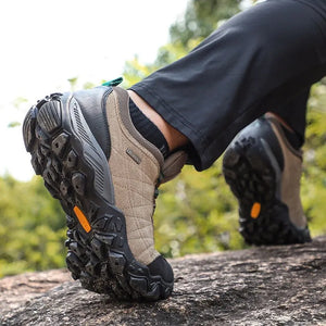 Hiking boots on a rocky surface with a natural background