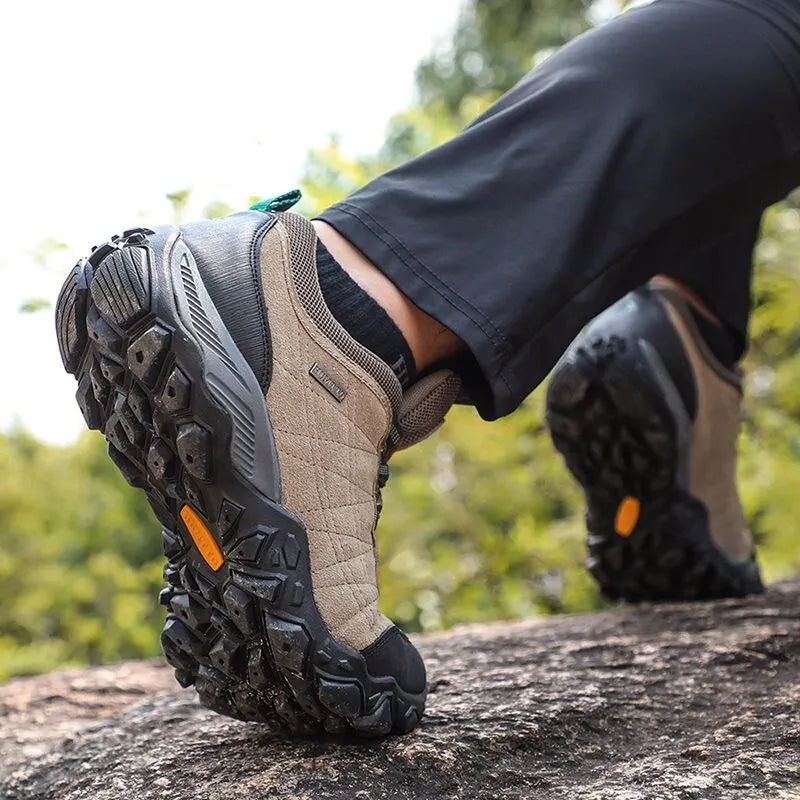 Hiking boots on a rocky surface with a natural background