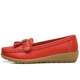Women's leather loafers with metal tassel detail, round toe, and rubber sole