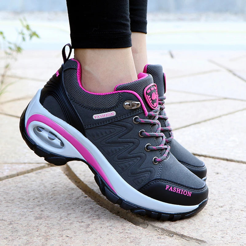 Gray and pink sneakers with 'Fashion' label on a pavement background