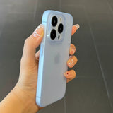 Hand holding a light blue Ultra thin matte translucent TPU iPhone case with a dark background