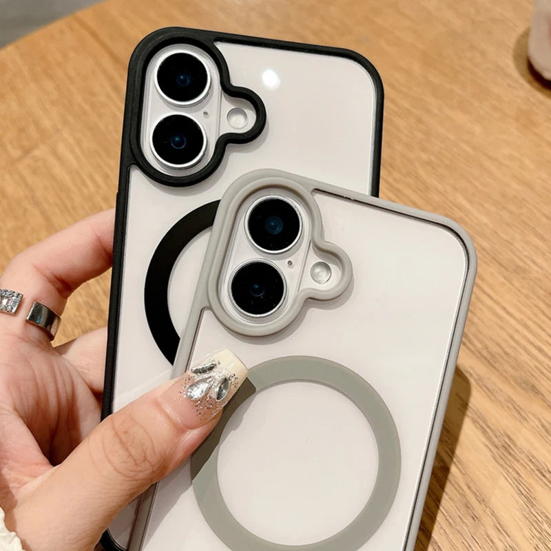 Two iphone cases with camera lens designs held by a hand on a wooden surface.
