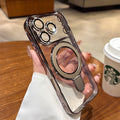 Luxury Transparent Plating iPhone Case Magnetic Ring Stand with ring holder held by a hand on a wooden table with a Starbucks cup in the background.