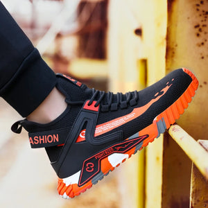 Black and orange safety shoe with 'FASHION' text on a blurred background