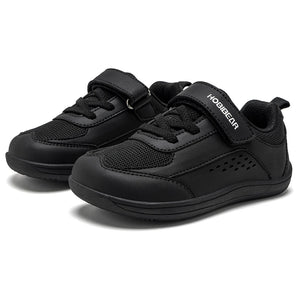 A pair of black toddler sneakers with mesh panels, hook-and-loop straps, and the brand name 'HODIBEAR' printed in white on the side strap, set against a plain white background.