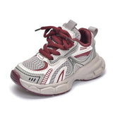 White and burgundy children's sneaker on a white background
