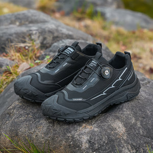 Black hiking shoes on a rock with a natural background