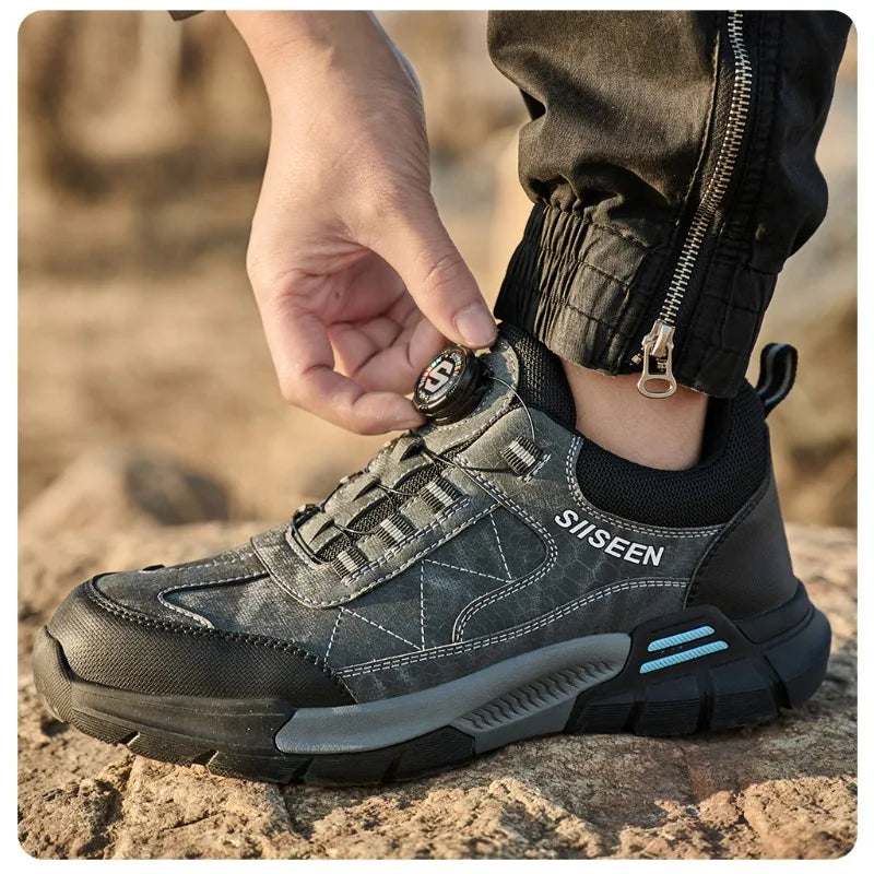 Person wearing a gray Safety Work shoe with 'SISEEN' branding on a rocky surface.