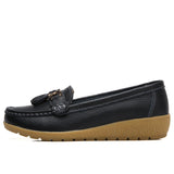 Women's leather loafers with metal tassel detail, round toe, and rubber sole
