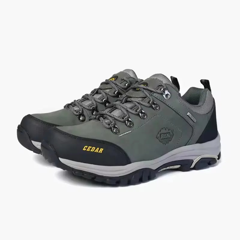 Gray hiking shoes with black soles on a white background