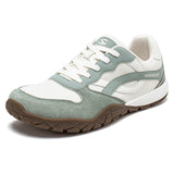 Green and white sneaker with brown sole on a white background