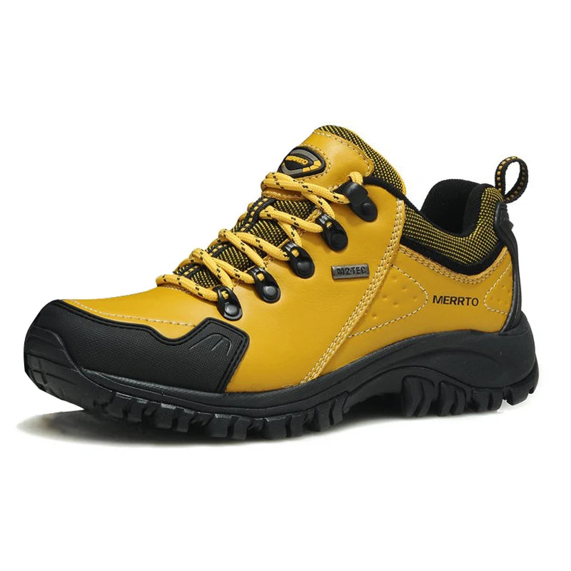 Yellow hiking shoe with black sole on a white background
