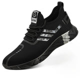 A black knit athletic sneaker with a textured sole, featuring three abstract silver and gray stripes on the side and a white tongue label with a black 'G' and 'GUY VISA' text.