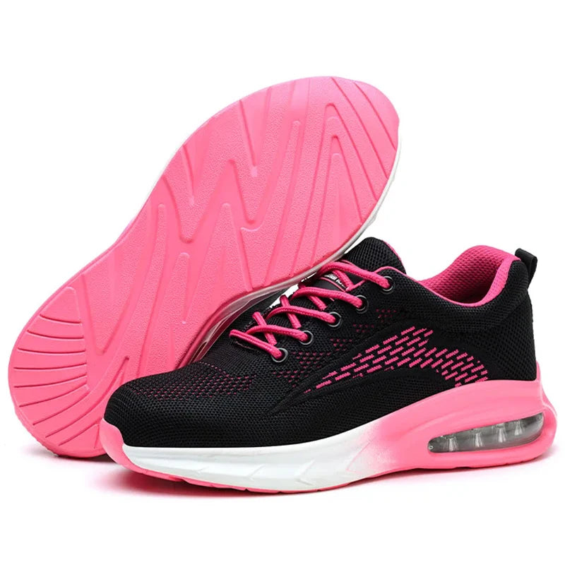 A pair of Women's Safety Work Shoes in black and pink, with one shoe showing the pink textured sole and the other showing the side profile with a pink-to-white gradient midsole and a visible air cushion unit.
