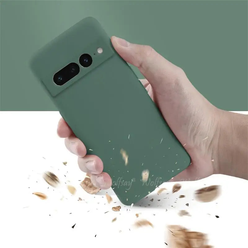 Hand holding a green Liquid Silicone Case for Pixel with a minimalistic design on a white background