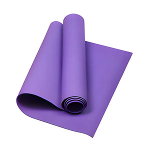 Purple yoga mat rolled up on a white background
