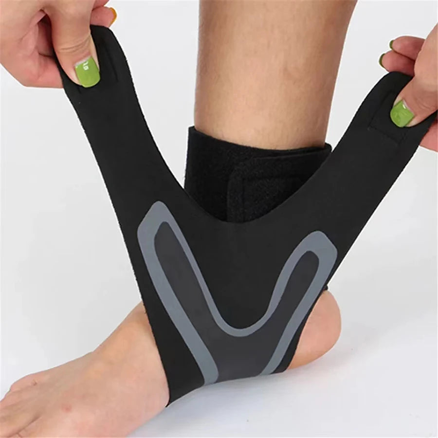 Person wearing a black ankle support brace on a white background