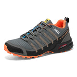 Gray and orange hiking shoe with brand logo on a white background