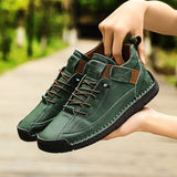 Green sneakers with brown accents held by a person outdoors
