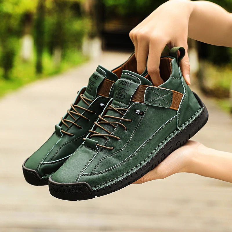 Green sneakers with brown accents held by a person outdoors