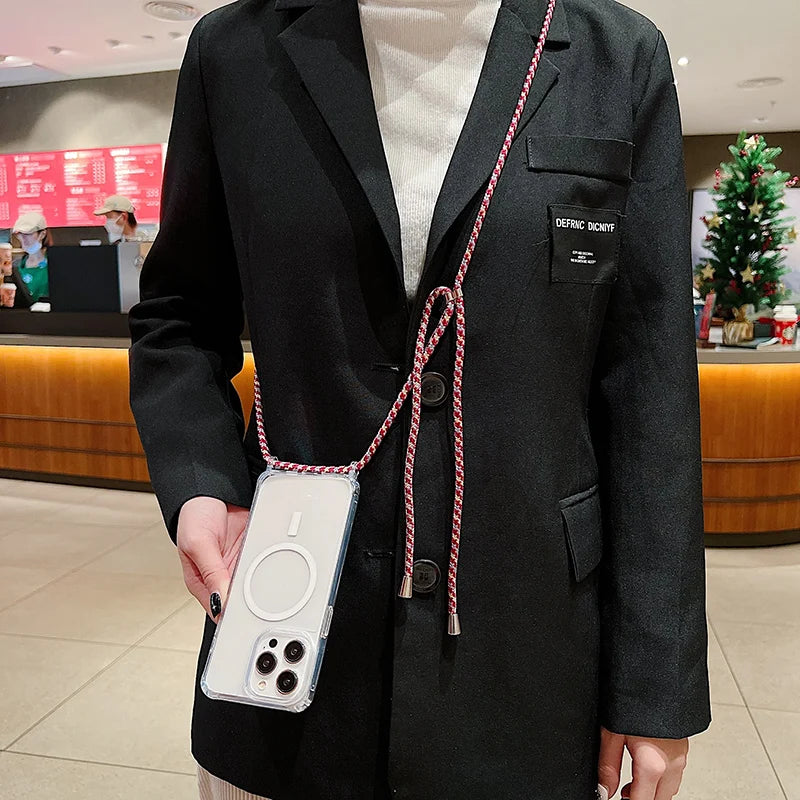 Person wearing a black blazer with a iphone case on a strap in an indoor setting