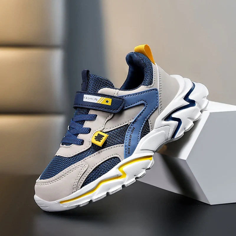 Children's sneaker with blue and gray design on a neutral background