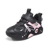 A black and pink low-top athletic sneaker with hook-and-loop straps, mesh panels, and decorative graphic details on a white background.